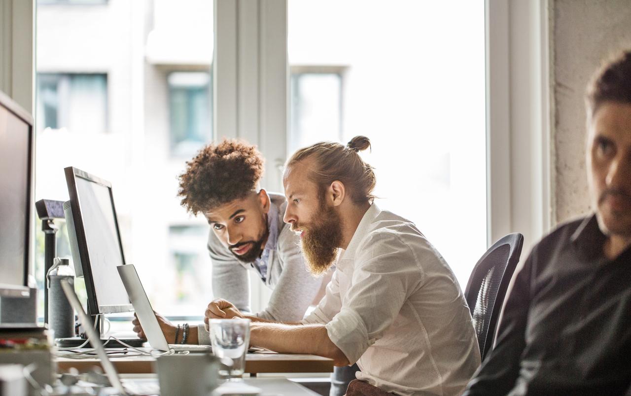 two men looking at computer screen together