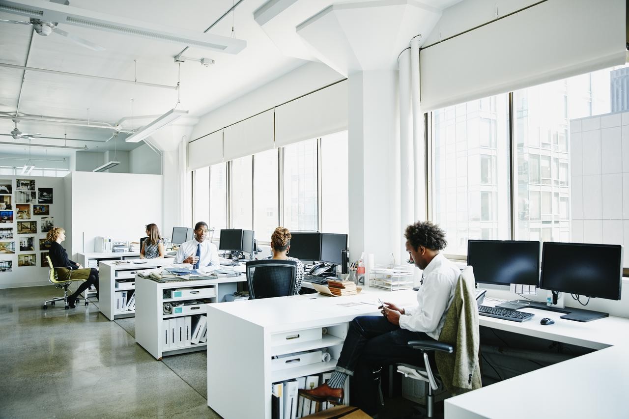 employees in a open space sitting at their desks